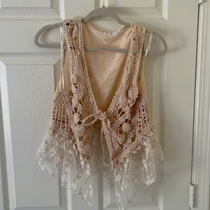 Cream crochet vest with lace bottom and tie front.